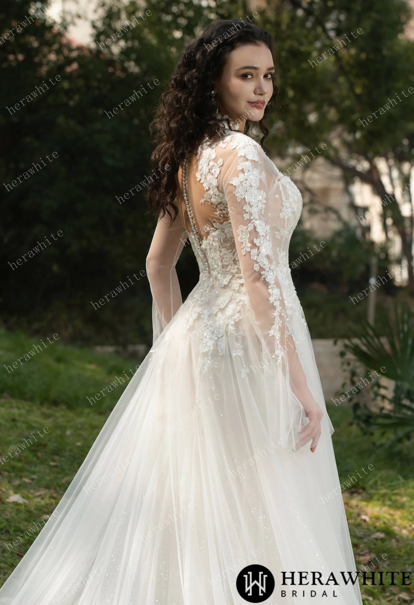 Side view of Bride wearing Ethel-Blossom long-sleeve lace wedding dress with tulle skirt.