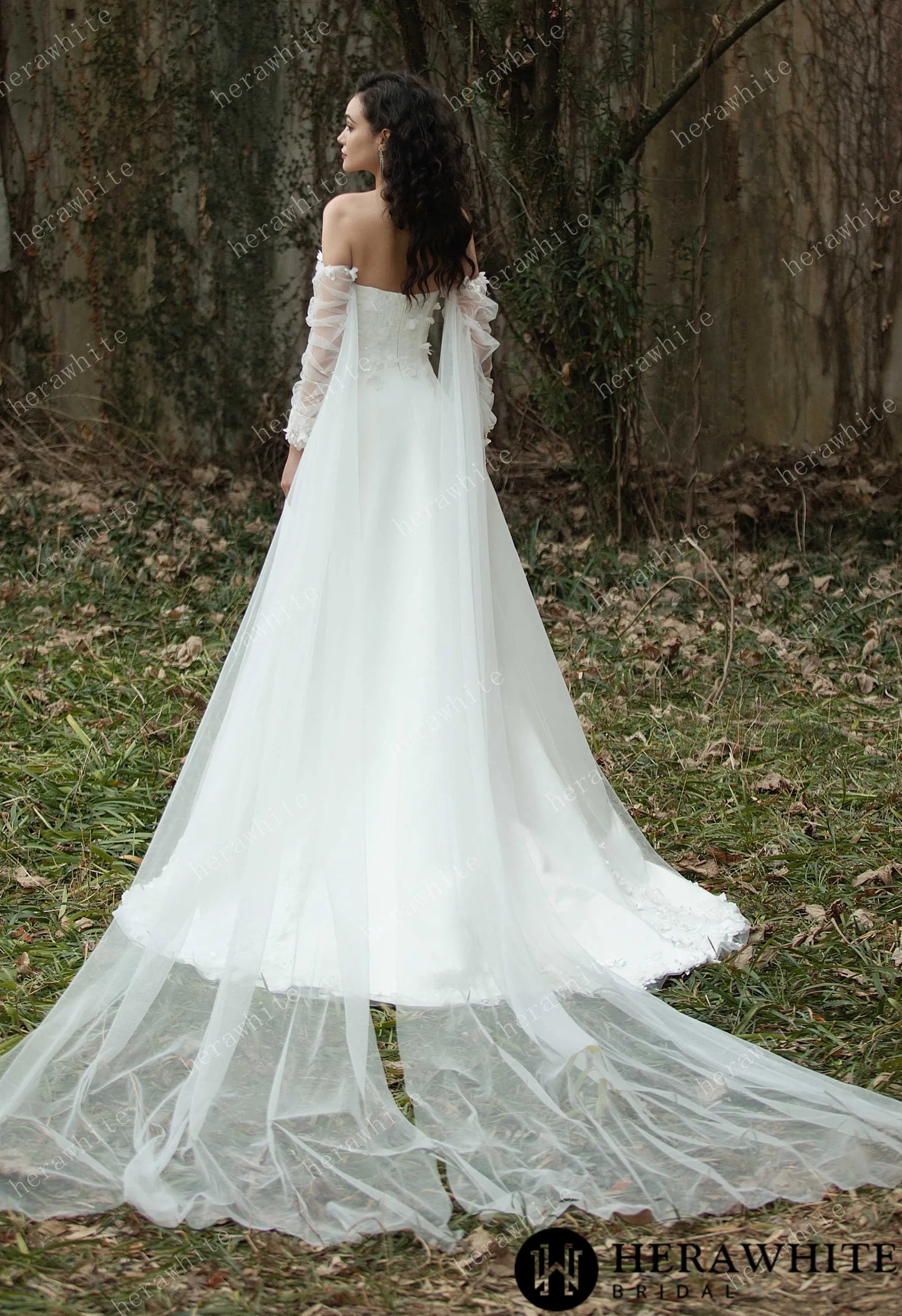 back view of a Bride wearing the Faith – Sweetheart Neckline Satin Bridal Gown with detachable sleeves & trailing Ribbons