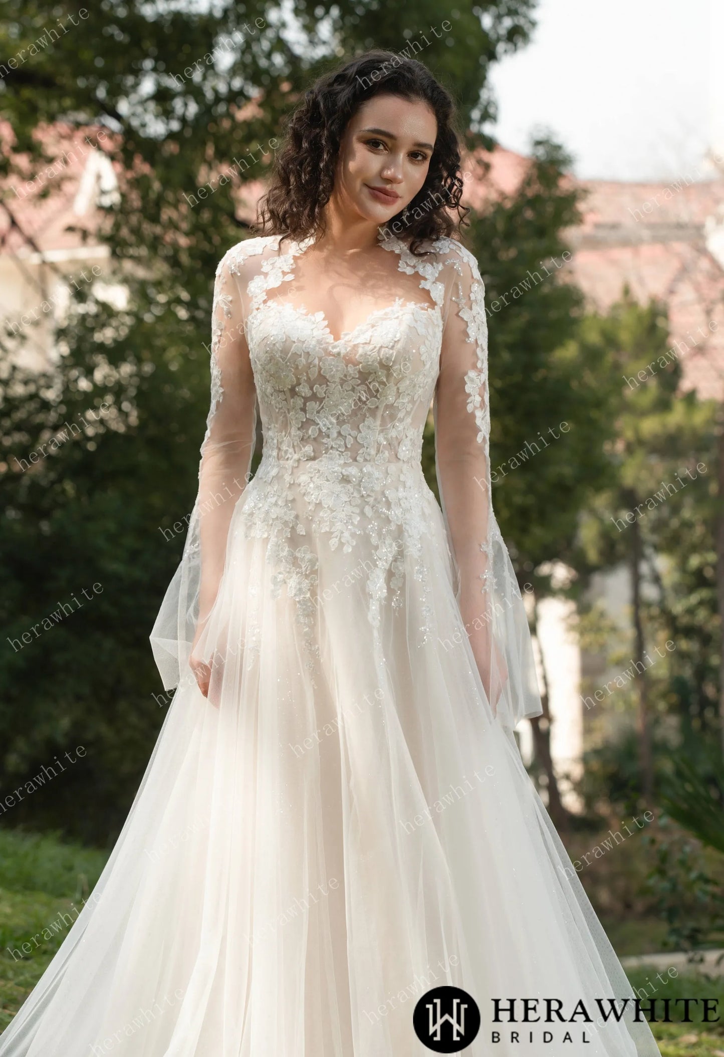 Bride wearing Ethel-Blossom long-sleeve lace wedding dress with tulle skirt.