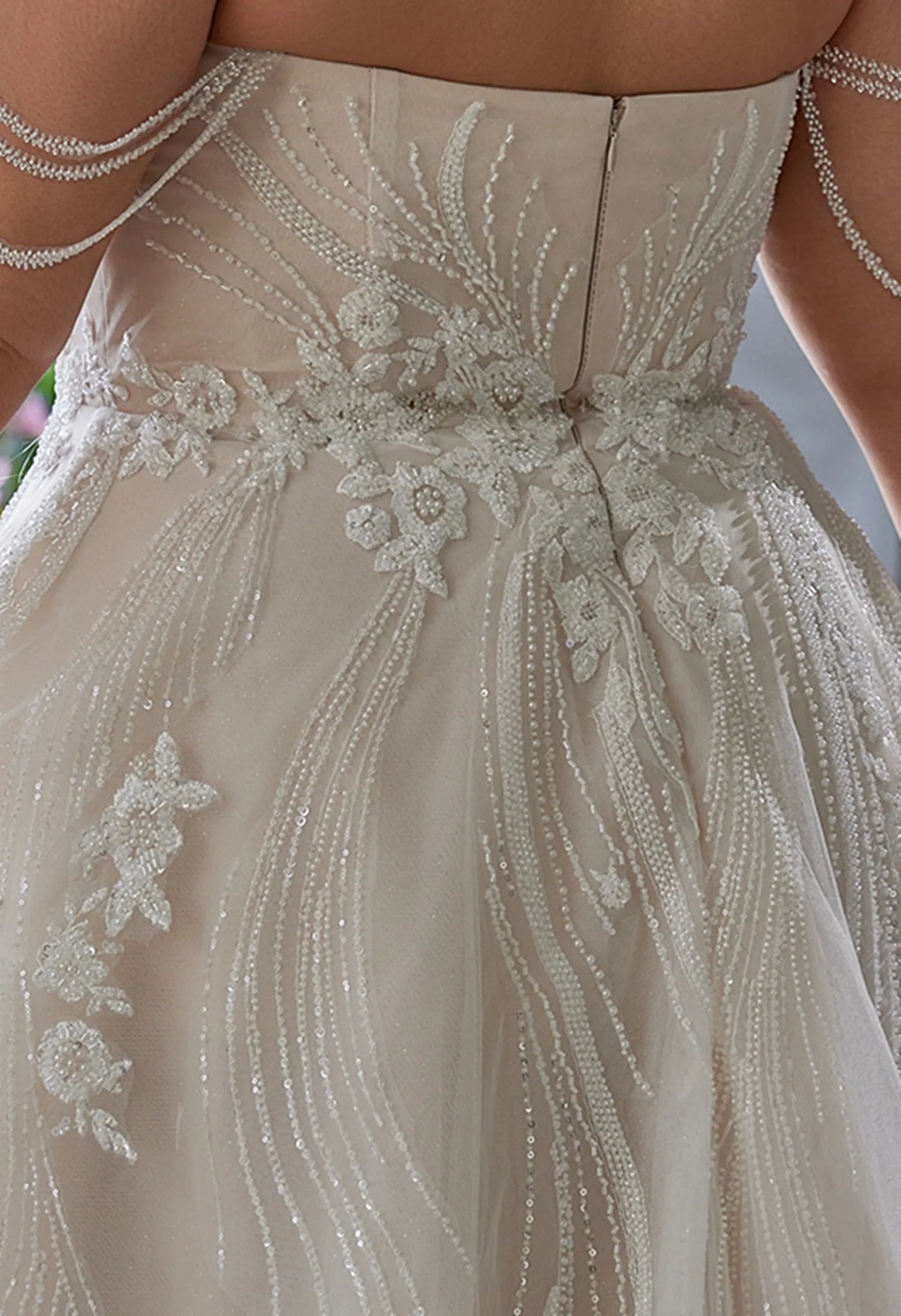 back has beadwork, lace flowers, and a zipper, elegant and detaile