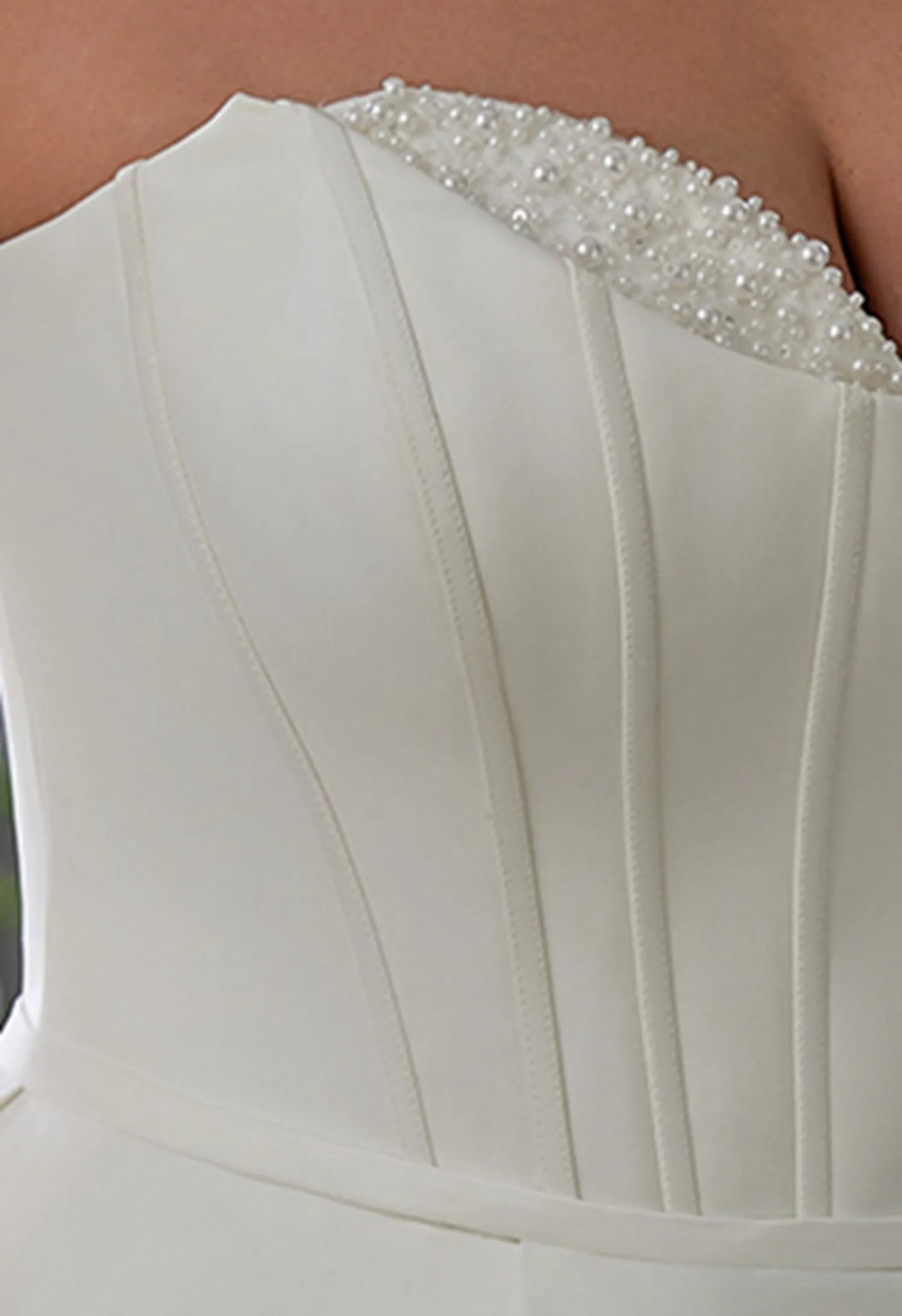 Gown uses boning for structure, offering support and a flattering, sculpted silhouette.