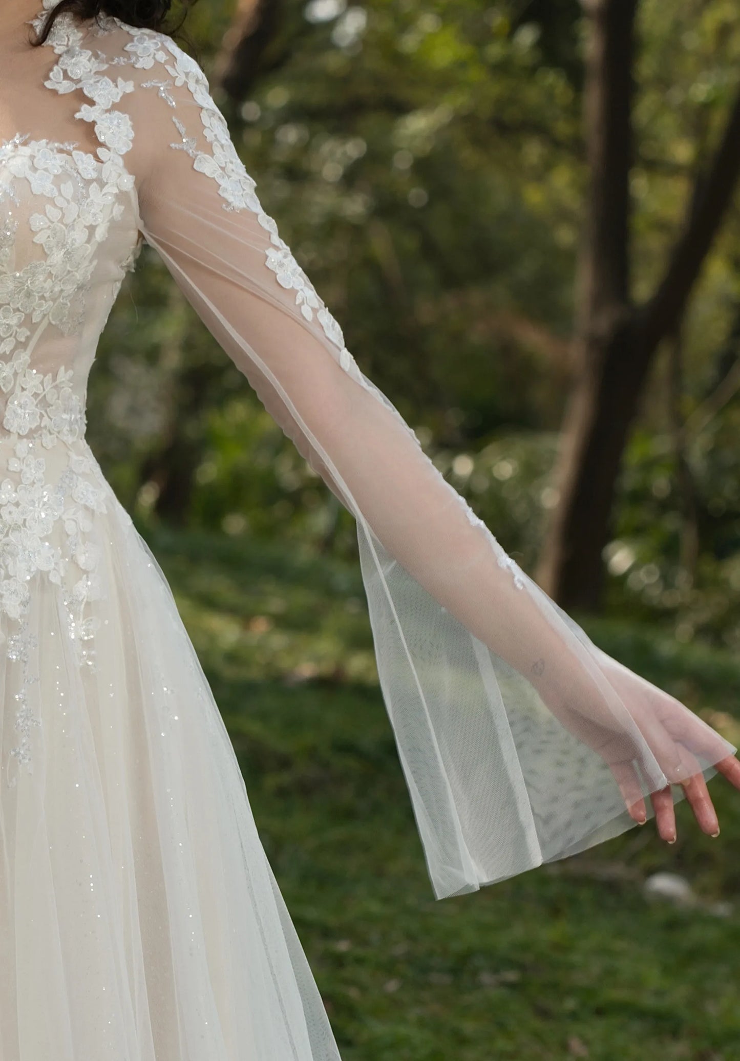 Sheer, flared sleeves adorned with delicate lace.