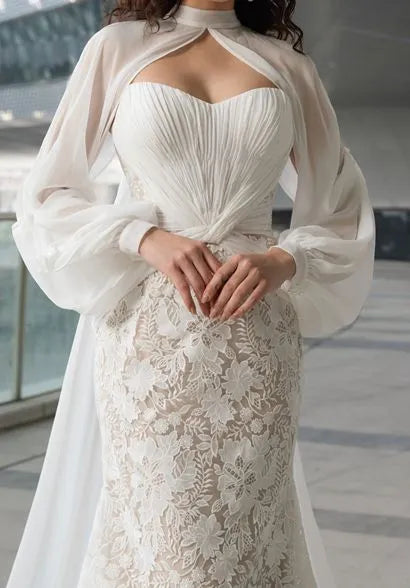 Detachable sheer sleeves add ethereal charm.