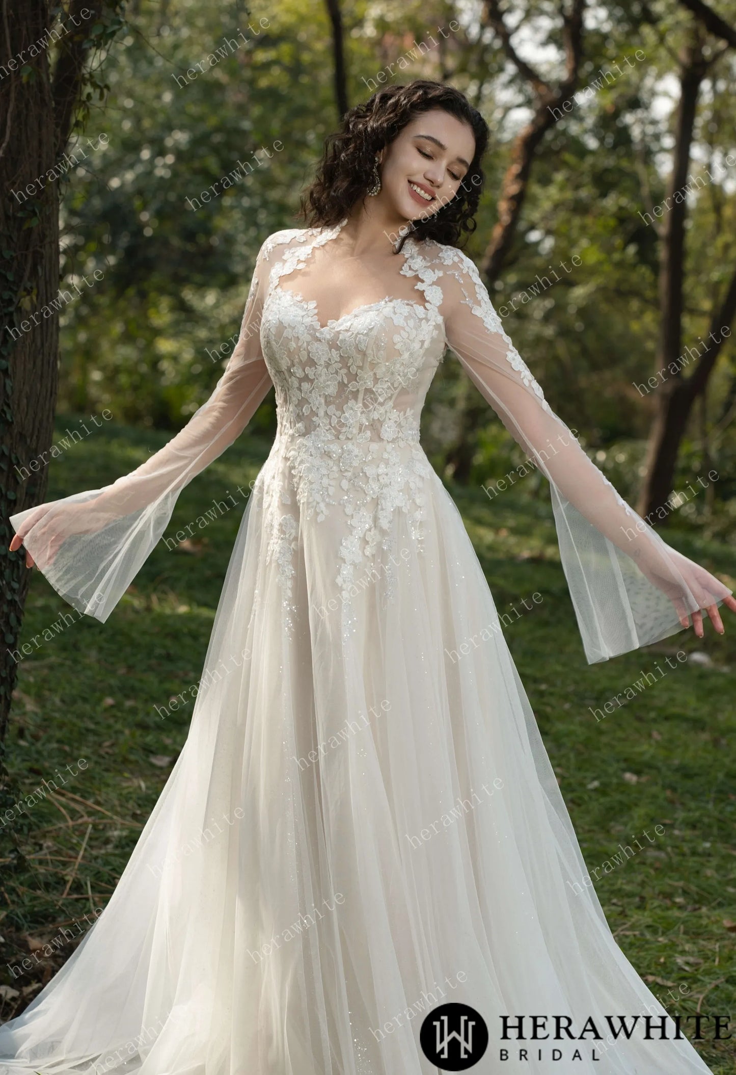 Bride wearing Ethel-Blossom long-sleeve lace wedding dress with tulle skirt.