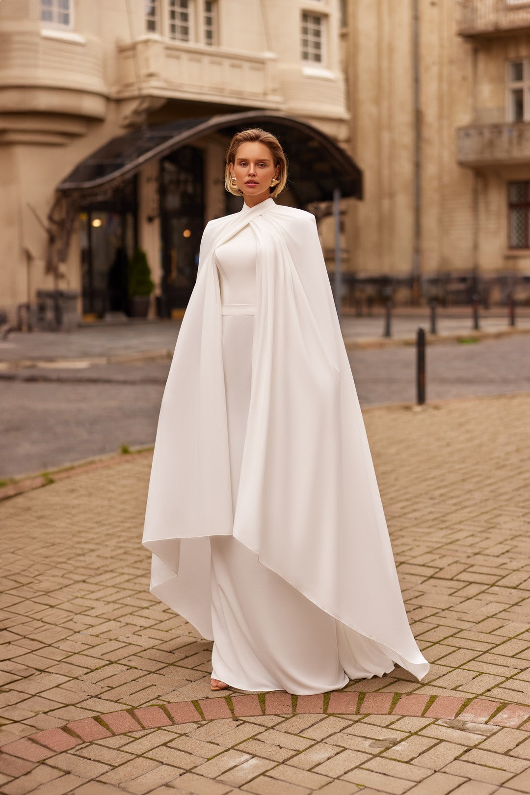 Bride wearing the LIRA Wedding Gown With Cape