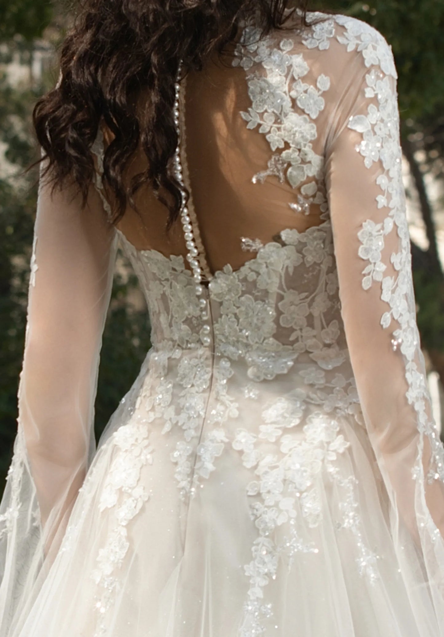 Open - back design with pearl - adorned detailing.