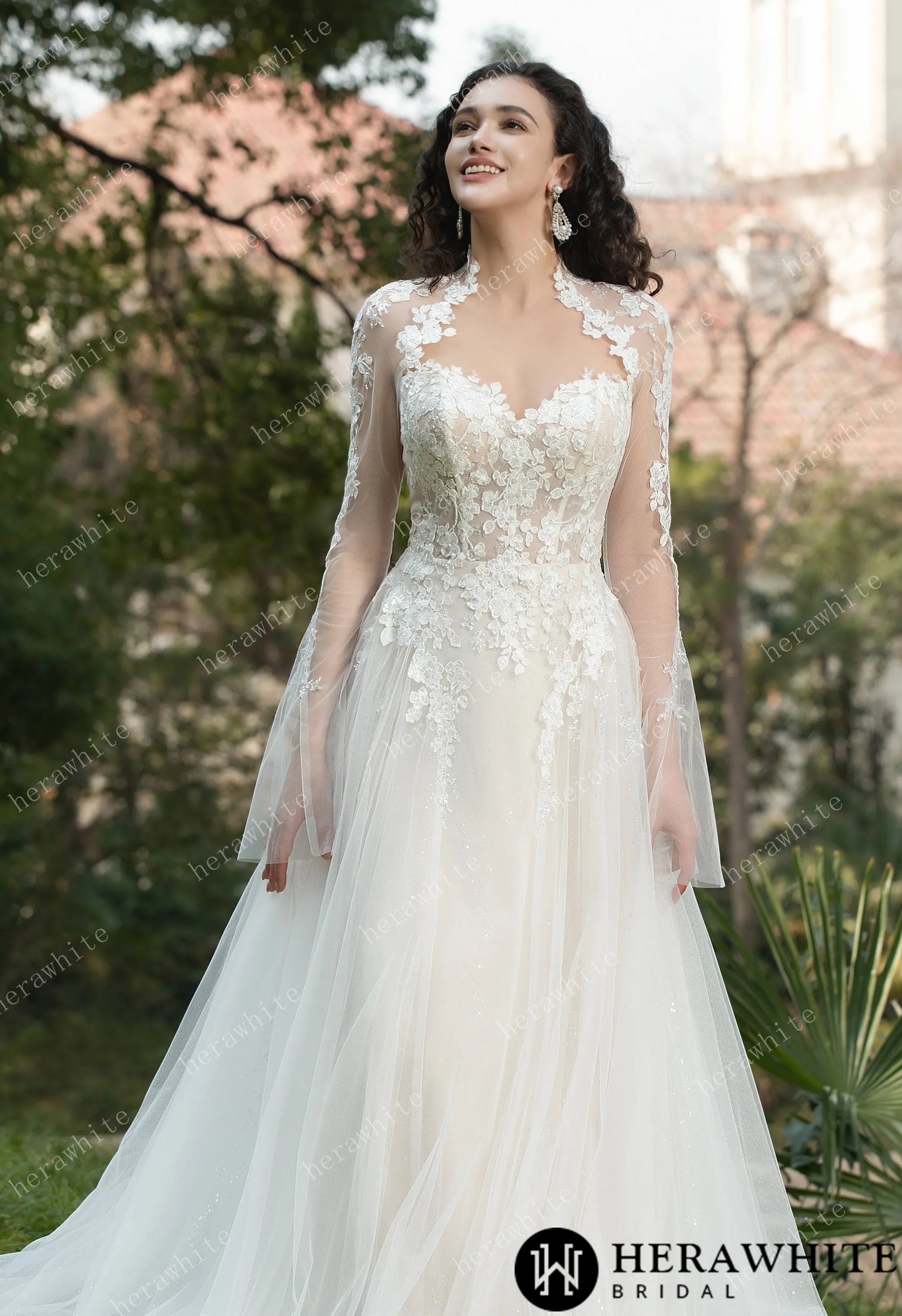 Bride wearing Ethel-Blossom long-sleeve lace wedding dress with tulle skirt.