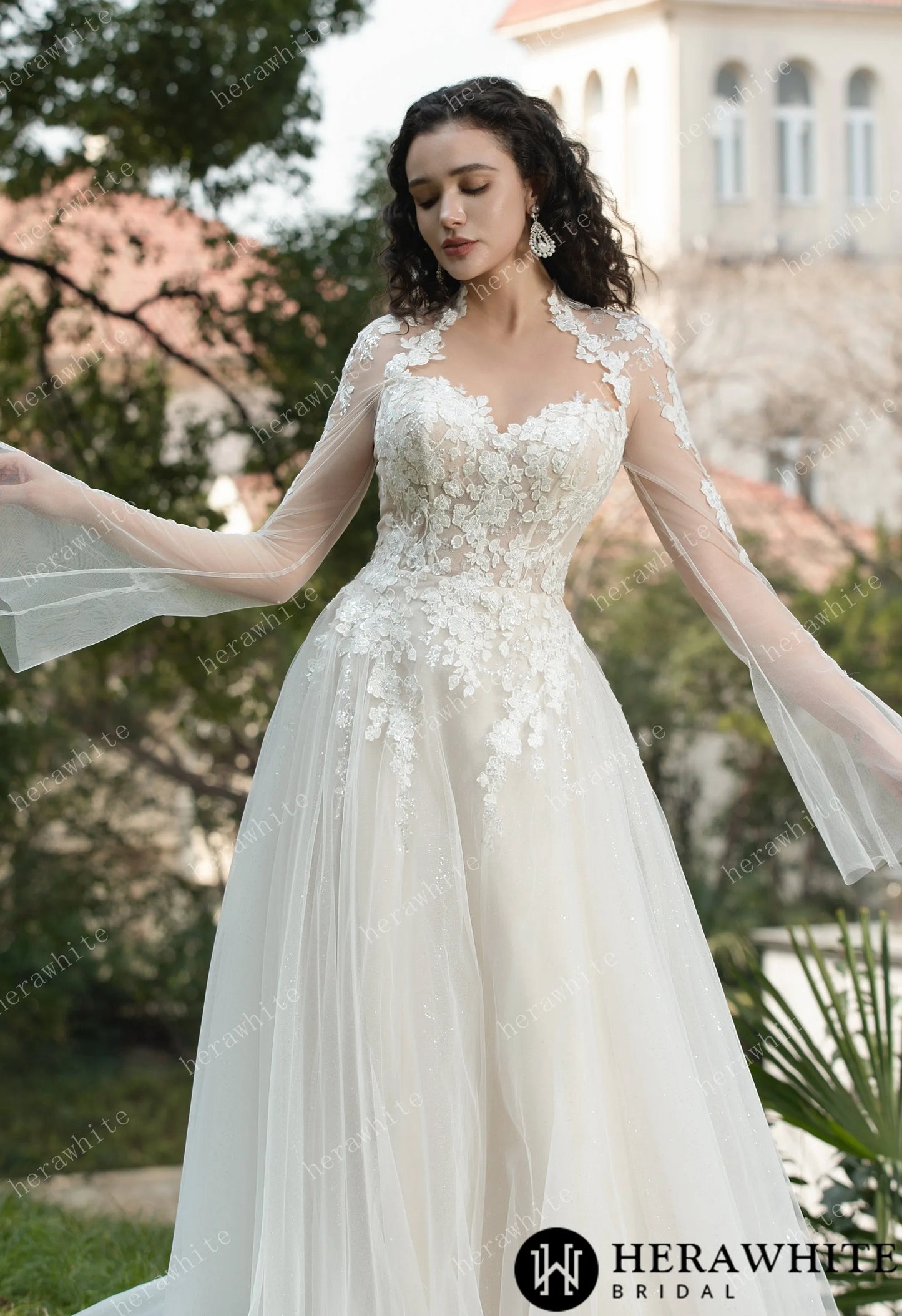 Bride wearing Ethel-Blossom long-sleeve lace wedding dress with tulle skirt.