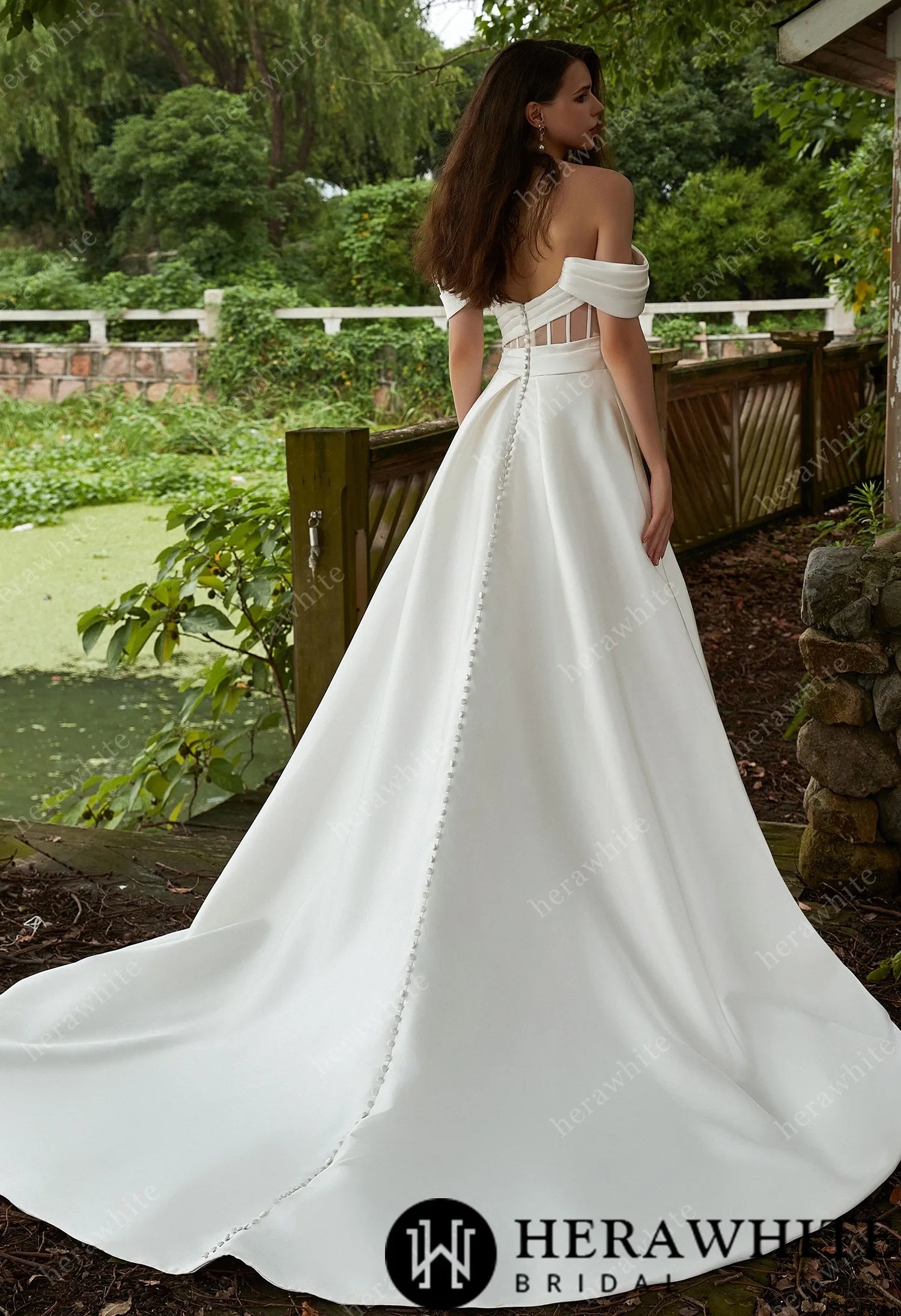 Modern bridal gown with bandeau neckline and illusion back