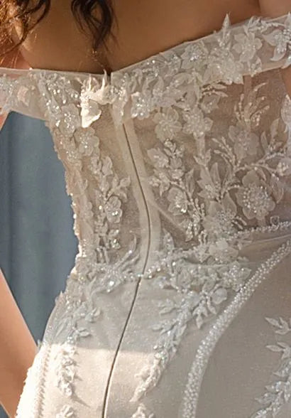 Back view showcasing lace patterns and zipper closure, merging design with functionality.