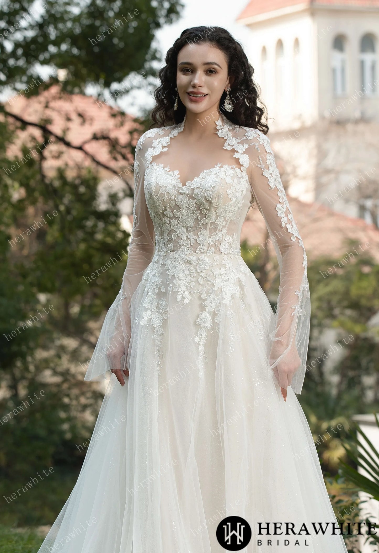 Bride wearing Ethel-Blossom long-sleeve lace wedding dress with tulle skirt.