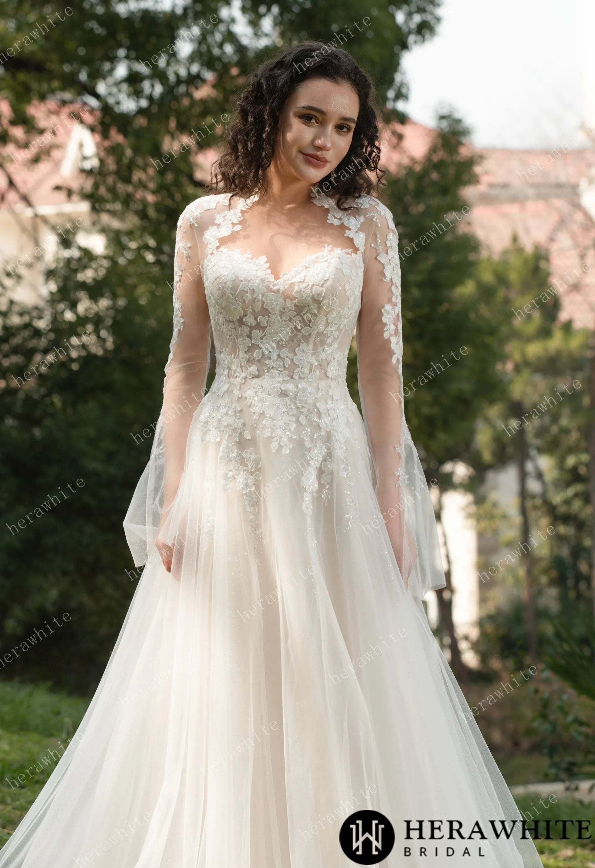 Bride wearing Ethel-Blossom long-sleeve lace wedding dress with tulle skirt.