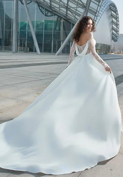 overview of Bride wearing the "Megan" Modern Glam-Off-the-Shoulder Bridal Gown with the detachable train.
