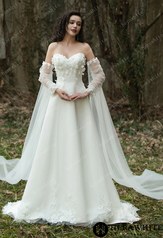 Bride wearing the Faith – Sweetheart Neckline Satin Bridal Gown with detachable sleeves & trailing Ribbons