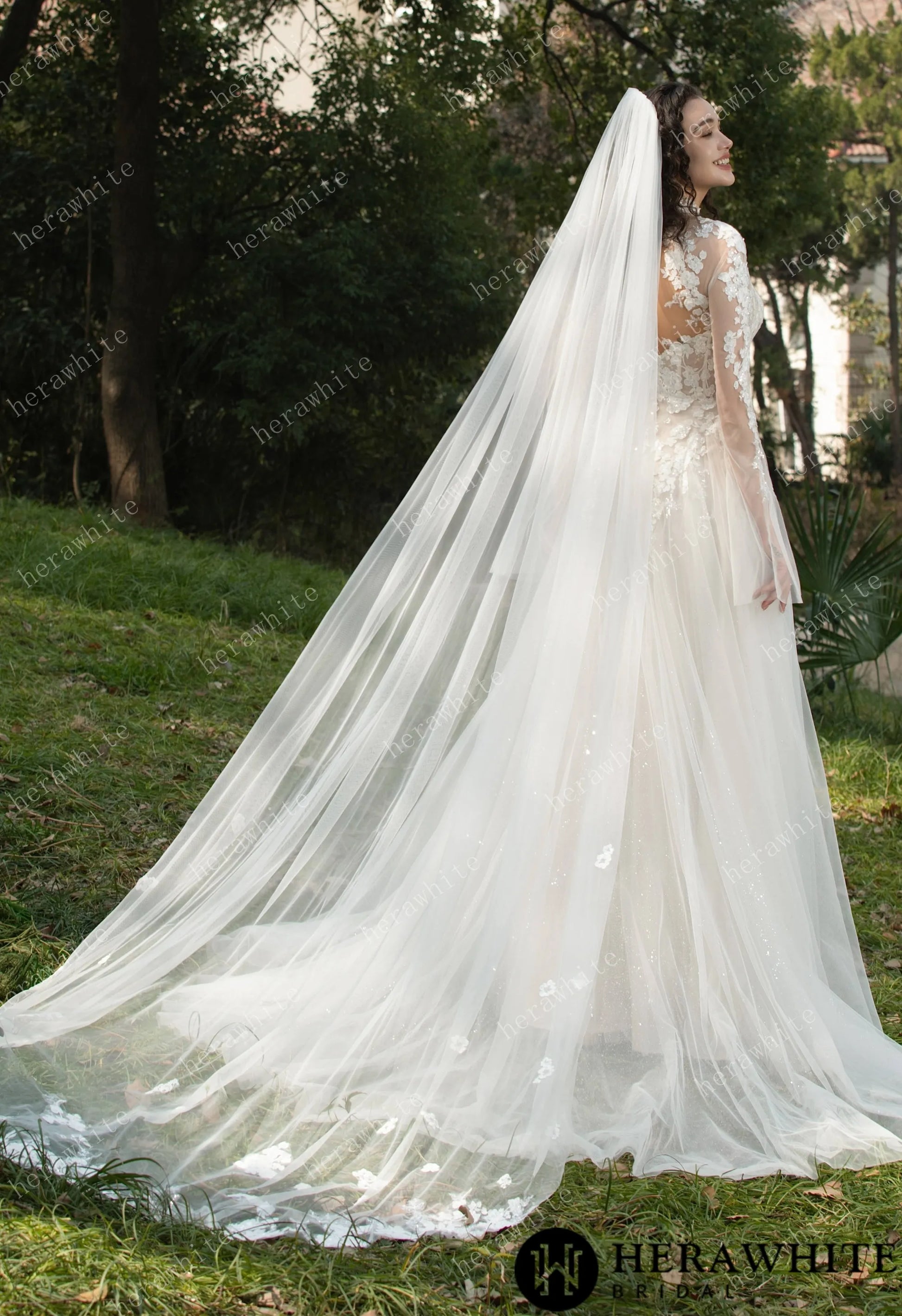 Back view of Bride wearing Ethel-Blossom long-sleeve lace wedding dress with tulle skirt and matching veil. 