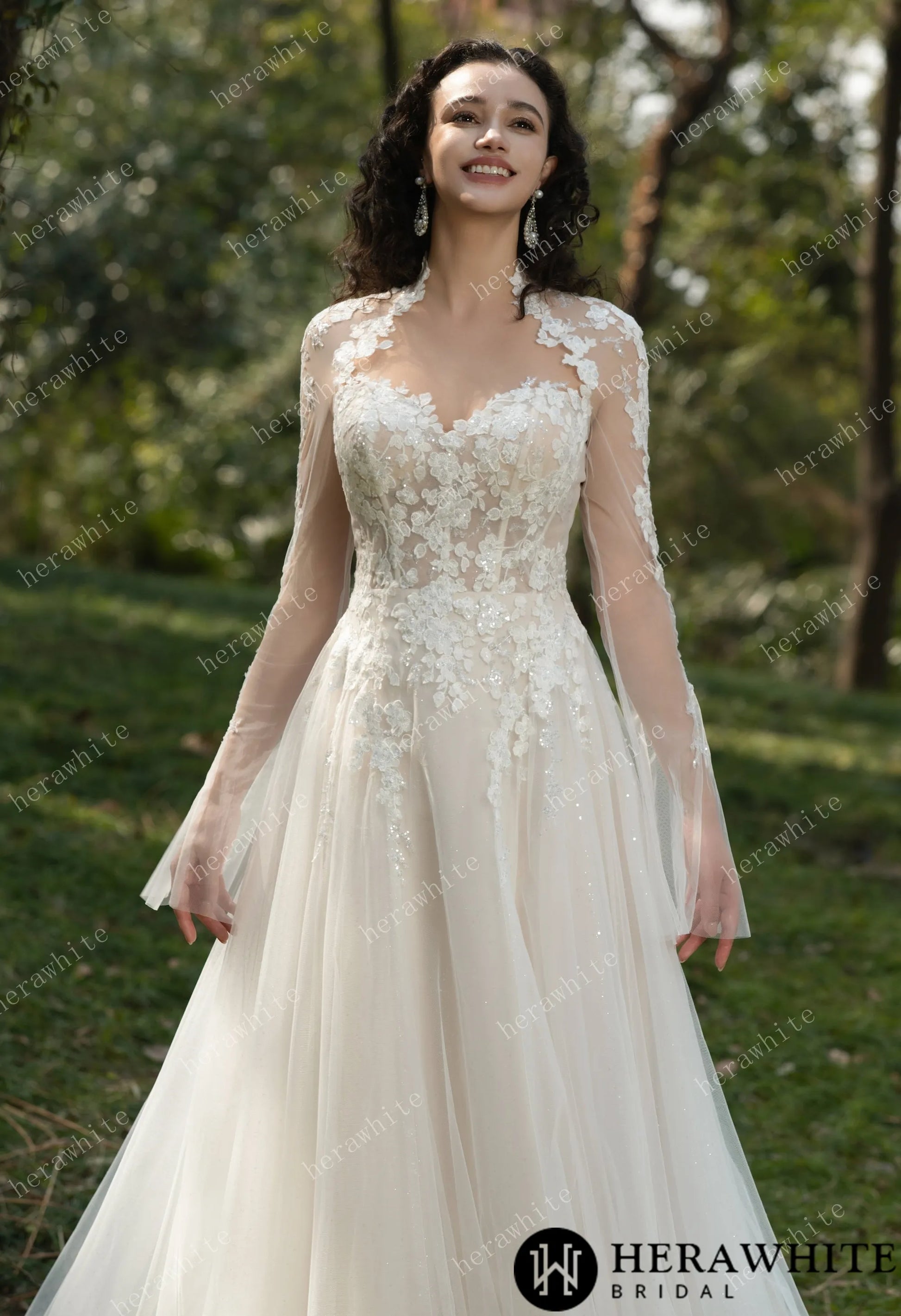 Bride wearing Ethel-Blossom long-sleeve lace wedding dress with tulle skirt.