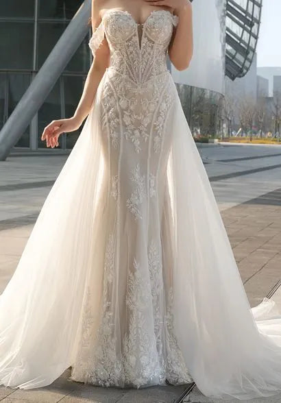Fit-and-flare gown with off-the-shoulder straps, paired with a detachable tulle train.