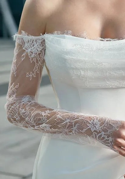 Detailed view of the off - the - shoulder long sleeves, showcasing the elegant lace embroidery and sheer fabric.
