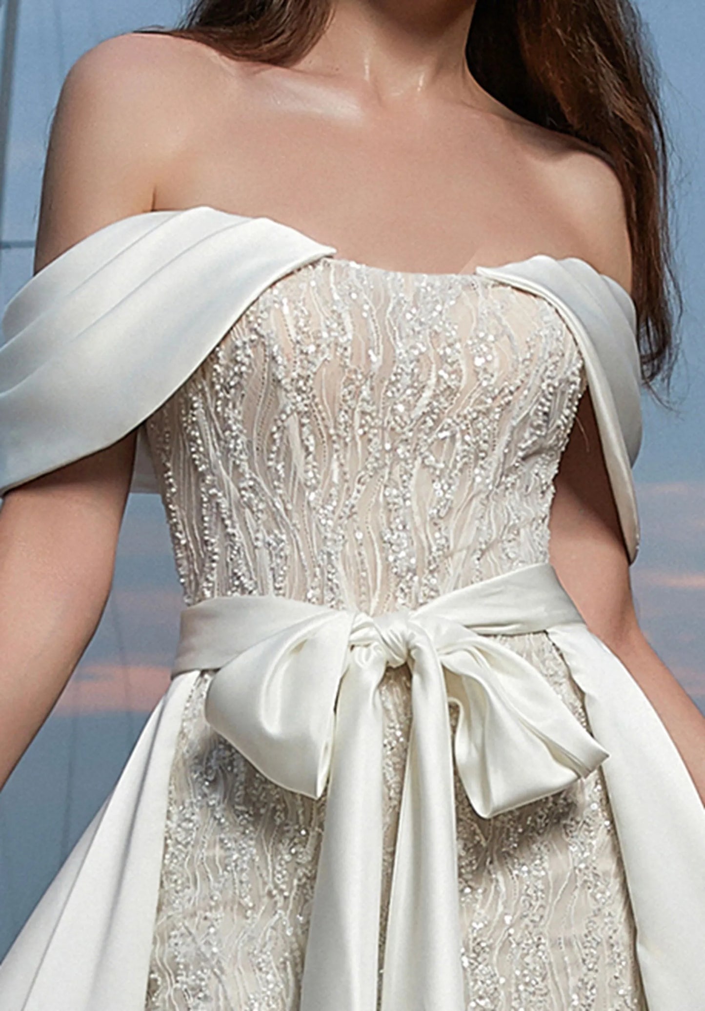 A sheer bodice at the back embellished with 3D beading.  