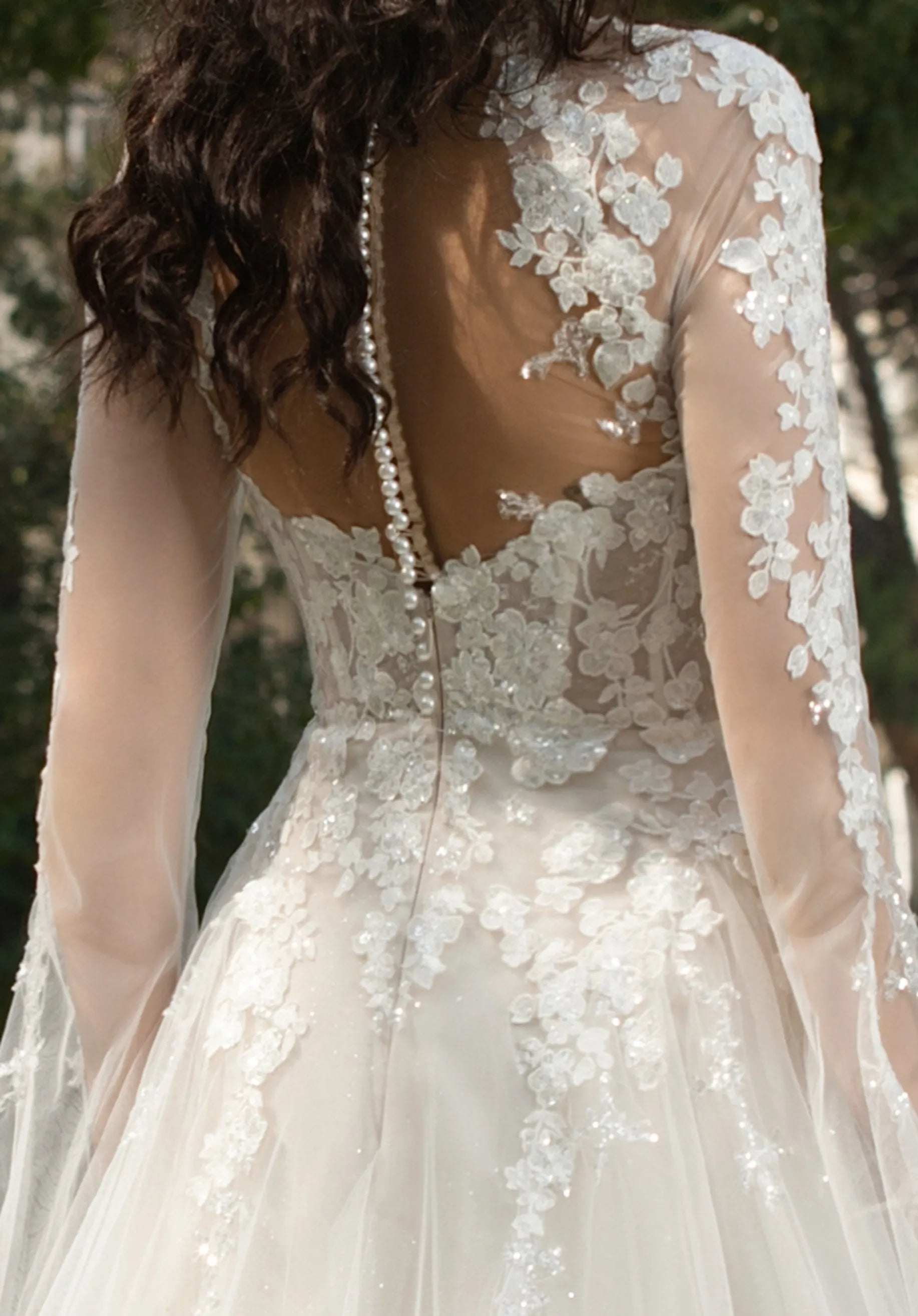 Open - back design with pearl - adorned detailing.