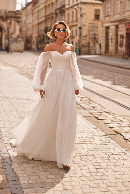 Bride wearing  the Petra Wedding Dress – A-Line Bridal Gown with Corset & Sheer Sleeves