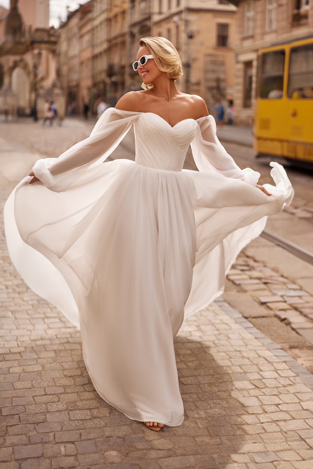 Bride wearing  the Petra Wedding Dress – A-Line Bridal Gown with Corset & Sheer Sleeves