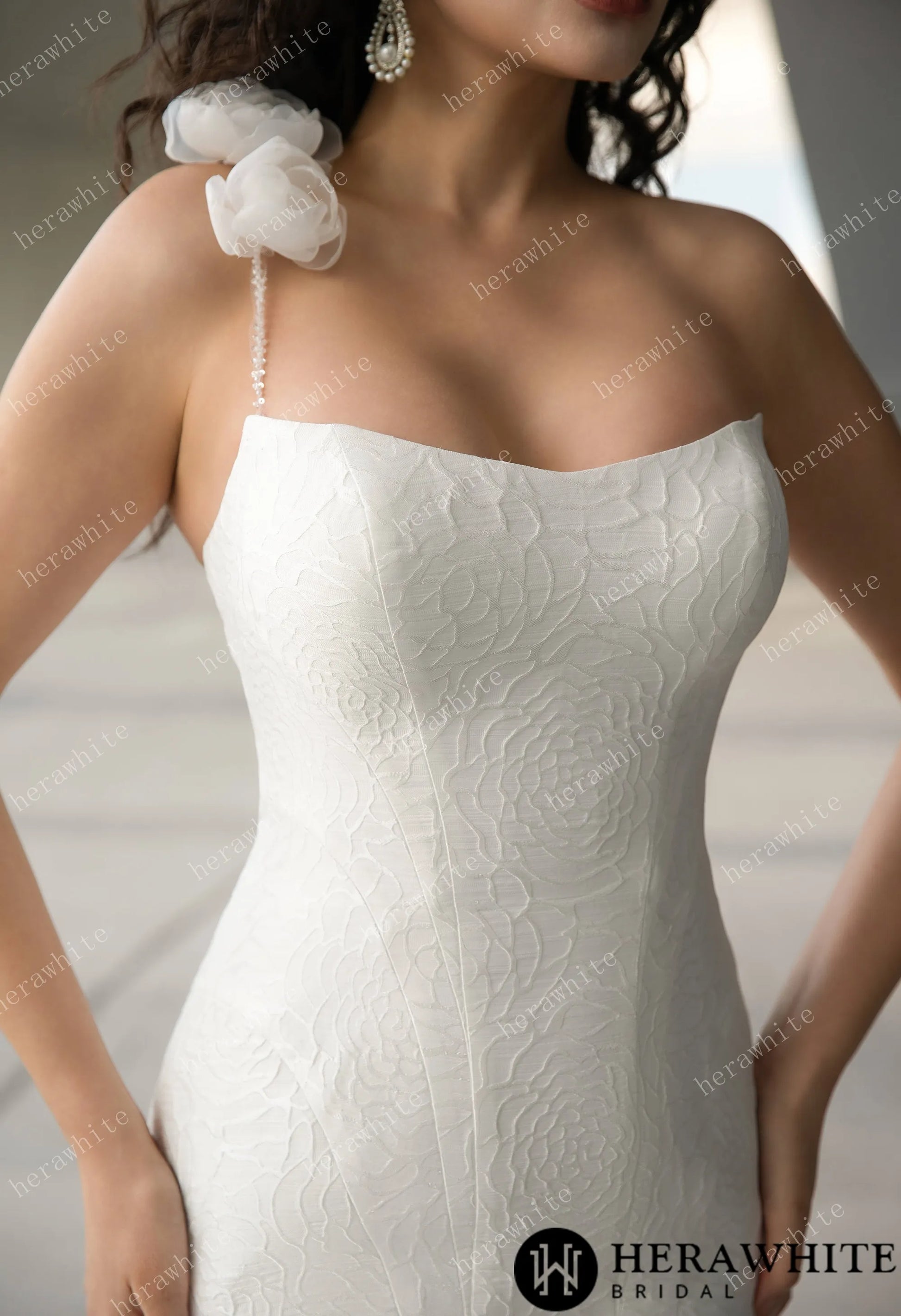 Closeup of the Georgianna -Jacquard satin mermaid wedding gown with single straps with tulle flowers