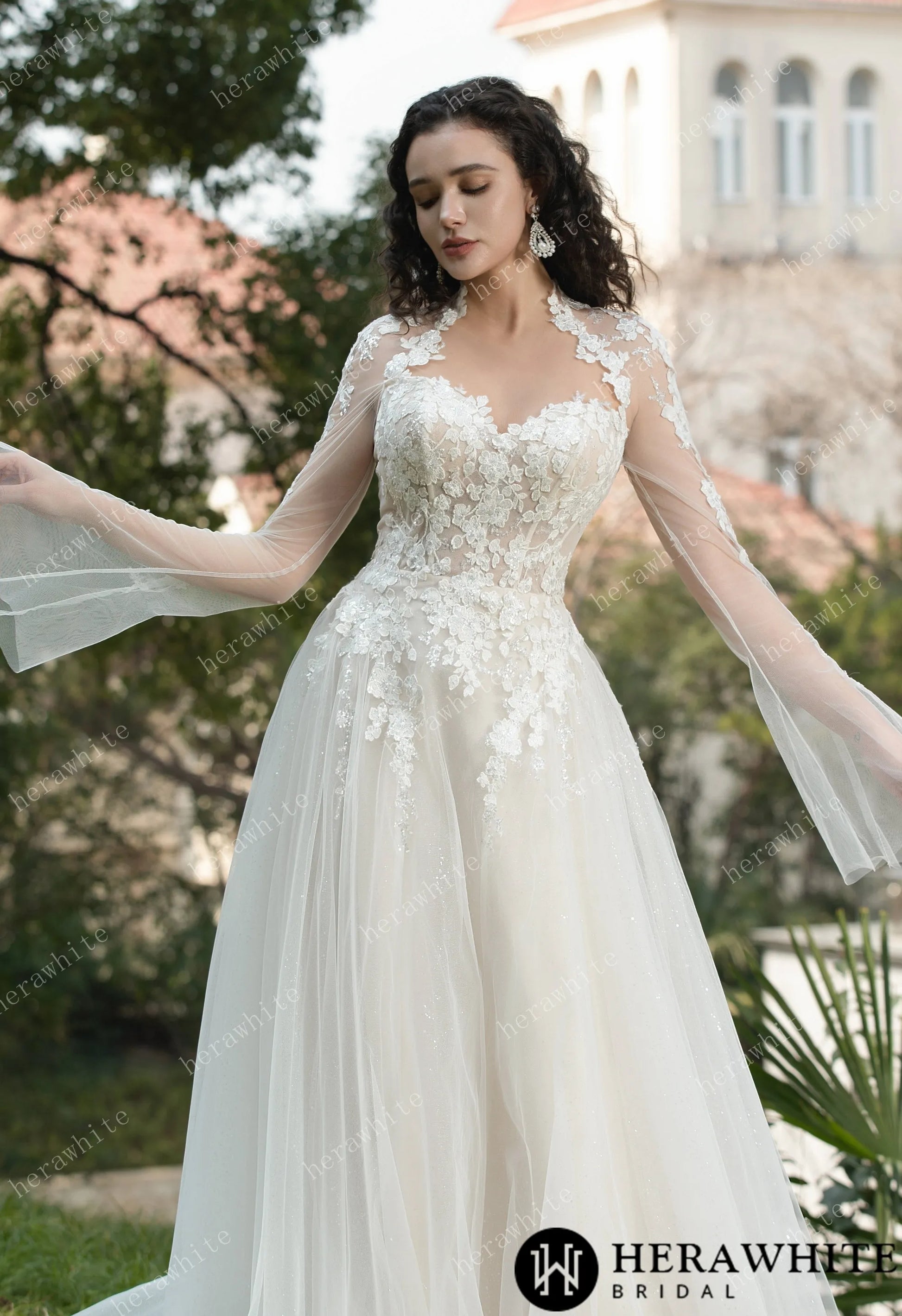 Bride wearing Ethel-Blossom long-sleeve lace wedding dress with tulle skirt.