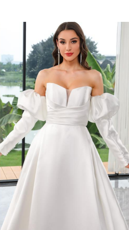 Ella Modern Wedding Gown with petal neckline, dramatic slit, and detachable puff sleeves.